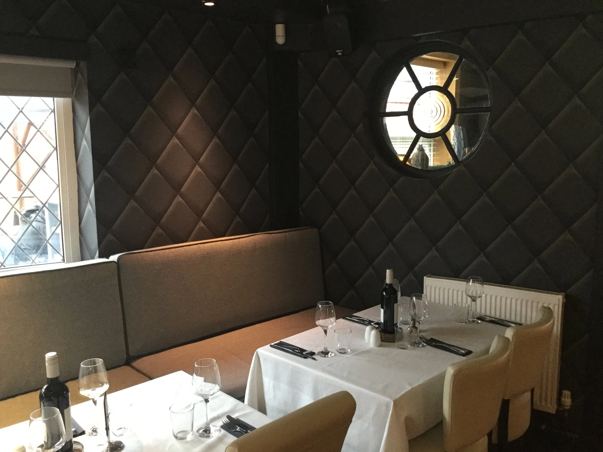 The quilted-wall dining room set for dinner